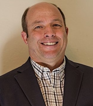 A man in a brown sports jacket