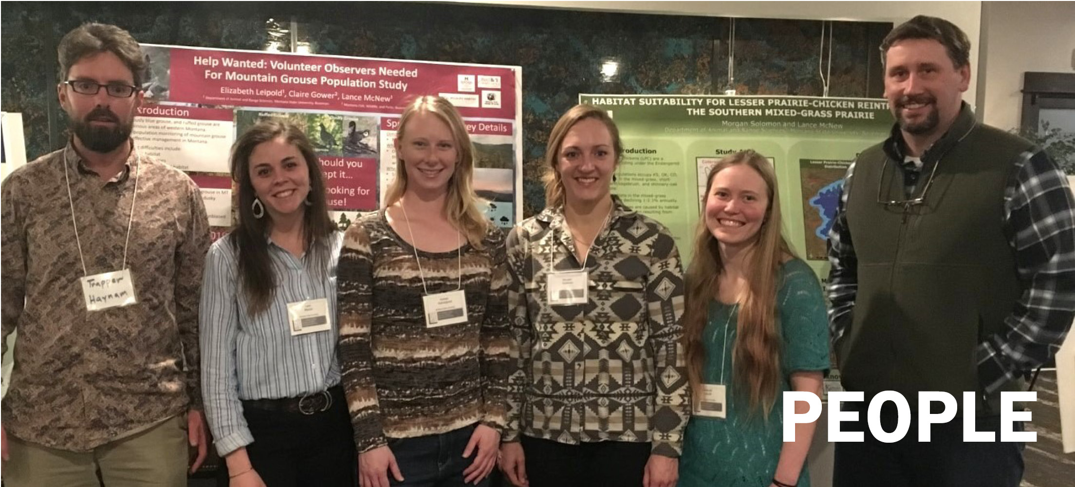 a group of students at a scholarly conference with their adviser