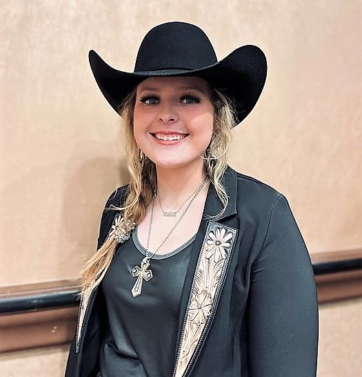 A young  blonde woman in a cowgirl hat