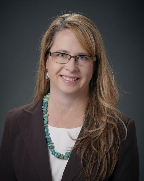 a woman with long hair and glasses