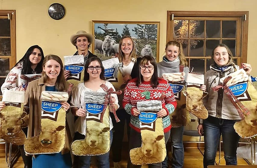 A group of college students holding stockings made from sheep feed bags